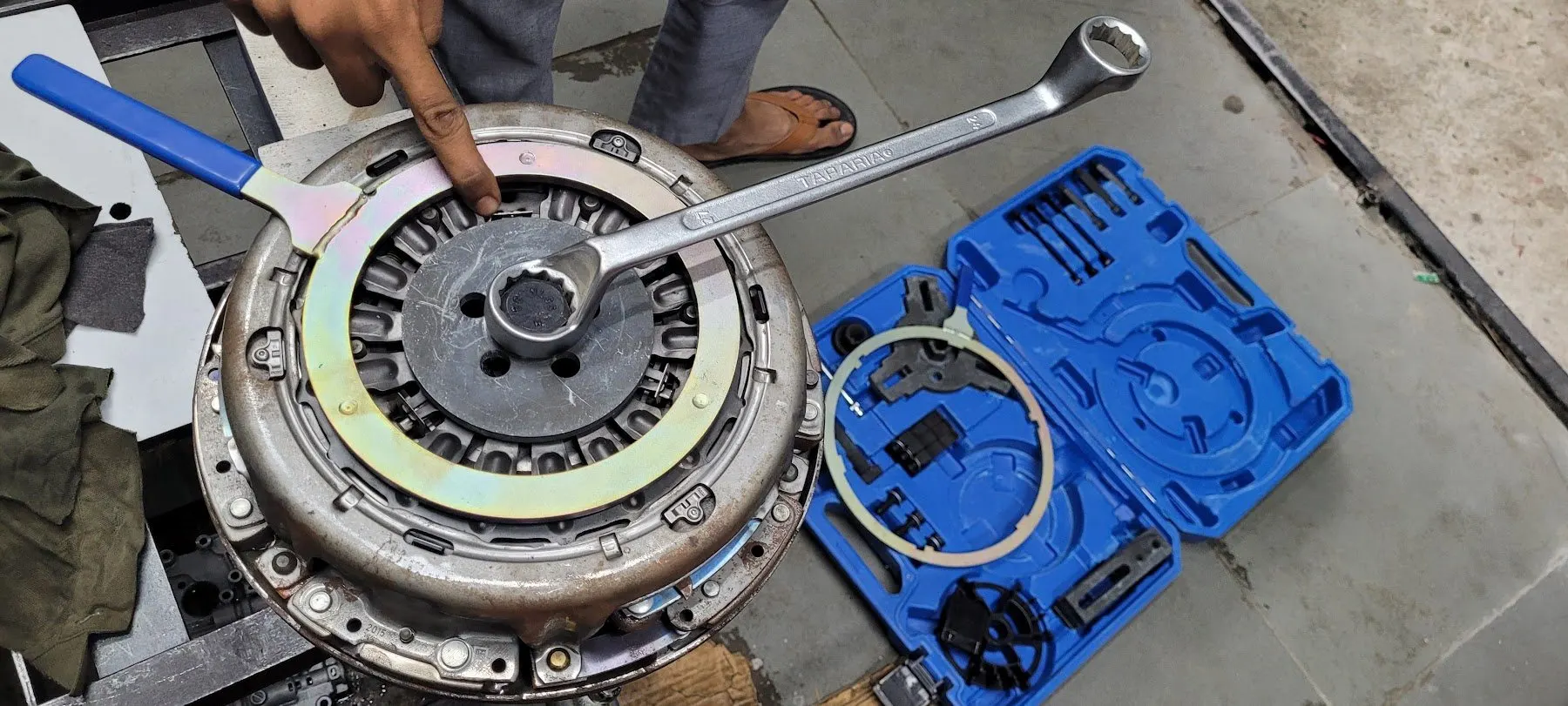 Clutch cover held in special tooling during a dual-clutch job