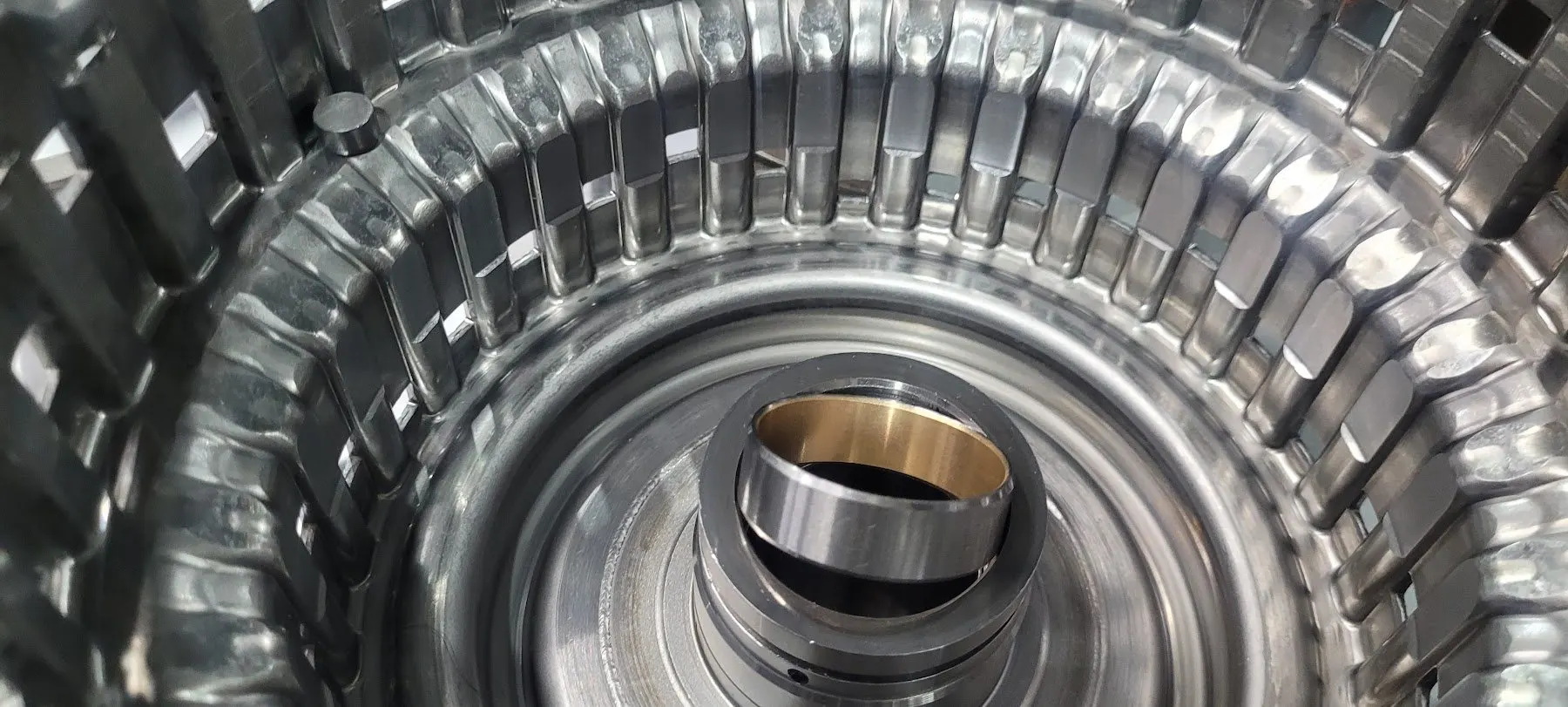 Close-up of a machined clutch drum and bronze bush inside an automatic gearbox